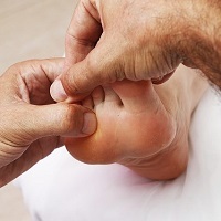 Reflexology treatment on a foot