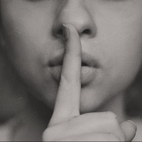 A finger to the lips indicating silence