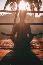 Silhouette of person meditating