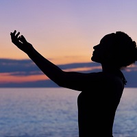 Silhouette of a woman with arms reaching out