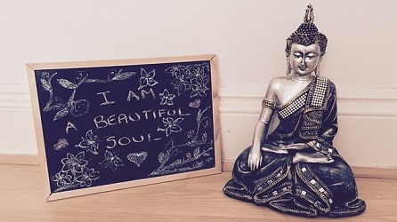 Statuette next to a chalk board reading I am a beautiful soul