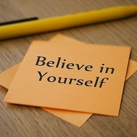 Text on a post it note reading believe in yourself