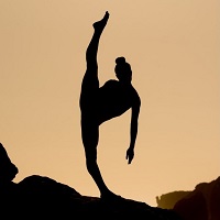 Ashtanga Yoga pose with one foot on the ground and the other high in the air