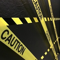 Yellow and black tape reading caution