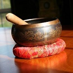 Tibetan singing bowl and mallet on a cushion
