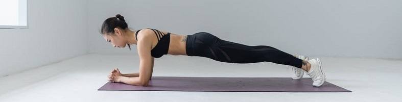 Profile of woman holding the plank yoga pose