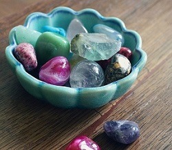 Bowl of various colourful crystals