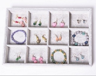 Jewellery box with compartments containing different crystal earrings and bracelets